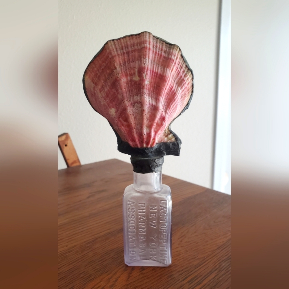 Vintage glass bottle with shell